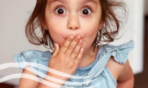 Oops! Surprised little girl with hand over mouth not sure about DIY dentistry.